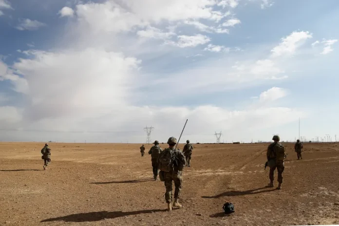 US Army soldiers on a reconnaissance patrol in a rural village near a coalition outpost in western Iraq [File: Susannah George/AP]