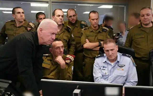 Defense Minister Yoav Gallant (left) IDF Chief of Staff Lt. Gen. Herzi Halevi (center), IAF chief Maj. Gen. Tomer Bar (right), and other officers are seen at the IAF's underground command room amid a strike on Hezbollah's headquarters in Beirut, September 27, 2024. (Ariel Hermoni/Defense Ministry)