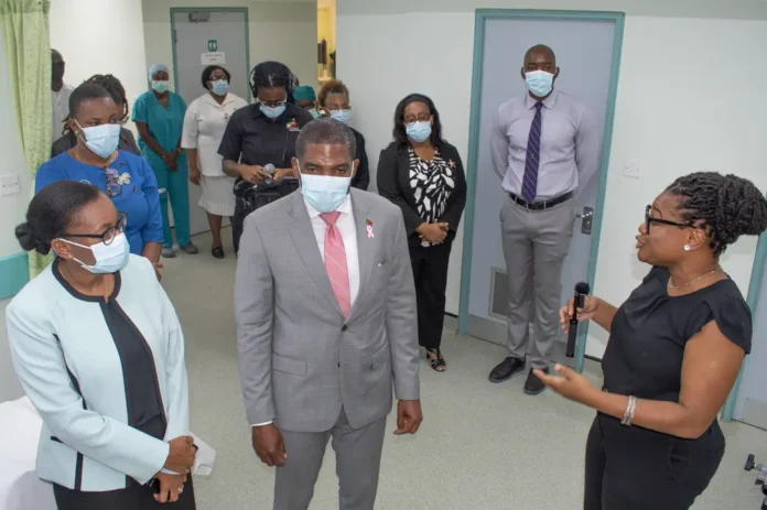 PM Drew at JNF General Hospital, examining new medical equipment