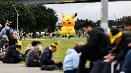 People play Pokemon Go on their smartphones during the opening day of the Pokemon Go tour at the New Taipei Metropolitan Park in New Taipei City on February 21, 2025.(I-Hwa Cheng/AFP)