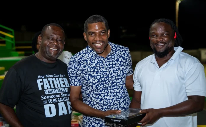 Prime Minister Dr. Terrance Drew extending gifts to the fathers on Father's Day celebration soccer match at Conaree Stadium in St. Kitts and Nevis