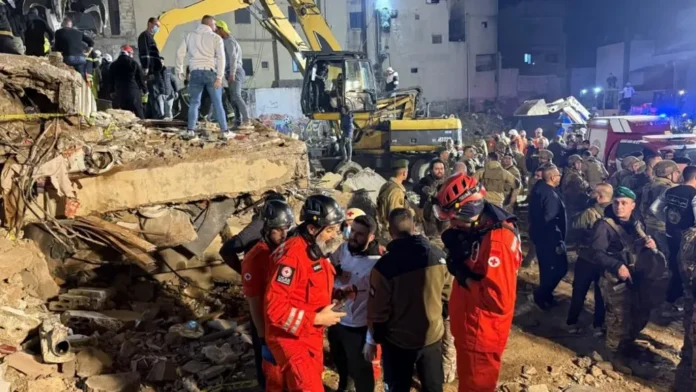 Rescue workers and residents gather amid debris after two residential buildings collapsed in Tripoli, leaving casualties and widespread destruction behind