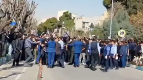 Students march through Tehran campus chanting slogans as security forces and government supporters confront demonstrators during tense protests